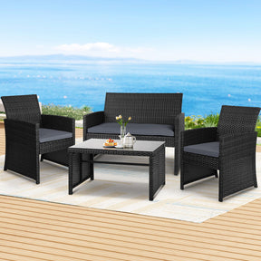 Kalaru black rattan outdoor sofa set with grey cushions and tempered glass coffee table poolside