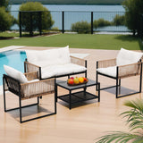 Black rattan wicker outdoor sofa lounge set with cushions on a sunny patio