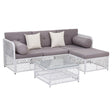 Five piece brown rattan outdoor sofa set with cushions and glass coffee table