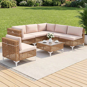 Seven piece rattan outdoor sofa set with cushions and glass coffee table on a patio
