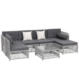 Seven piece brown rattan outdoor sofa set with cushions and glass coffee table