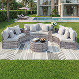 Nine piece rattan outdoor sofa set with cushions and glass coffee table on a deck