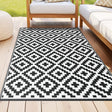 Sawtell reversible polypropylene outdoor rug 120 by 180cm on a patio