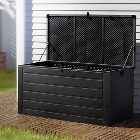 Cowell all black weather resistant outdoor storage box in a garden