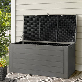 Cowell black weather resistant outdoor storage box in a garden