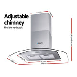 Glass canopy range hood shown at an angle with chimney