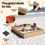 Children playing at wooden sandpit mud kitchen