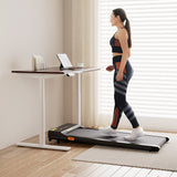 Deakin walnut electric standing desk with walking pad in a home office