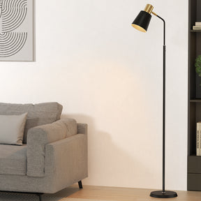 Auden slim modern black LED floor lamp beside a reading chair
