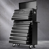 Black 16 drawer steel tool chest with open drawers in a garage workshop