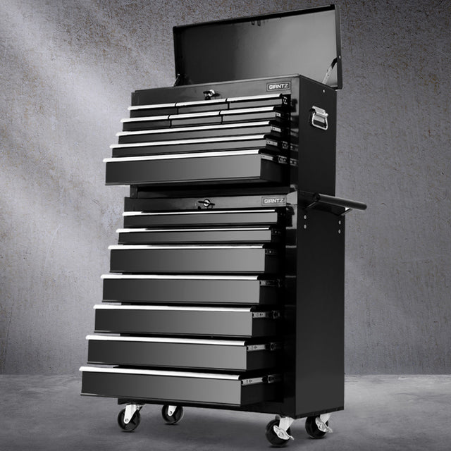 Black 16 drawer steel tool chest with open drawers in a garage workshop