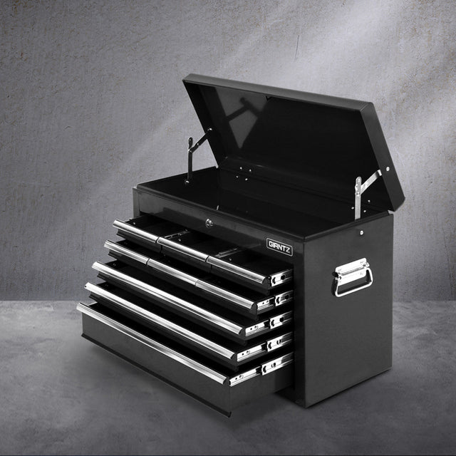 Black 9 drawer steel tool chest with open drawers in a garage workshop