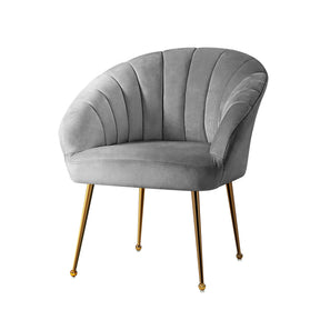 Clarence grey velvet armchair with solid wood legs in a reading corner