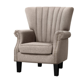 Sun Valley beige wingback armchair with button stud detail in a study