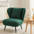 Hartley green corduroy wingback chair in a modern living room