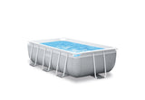 Rectangular above ground metal frame swimming pool with filter pump in a backyard
