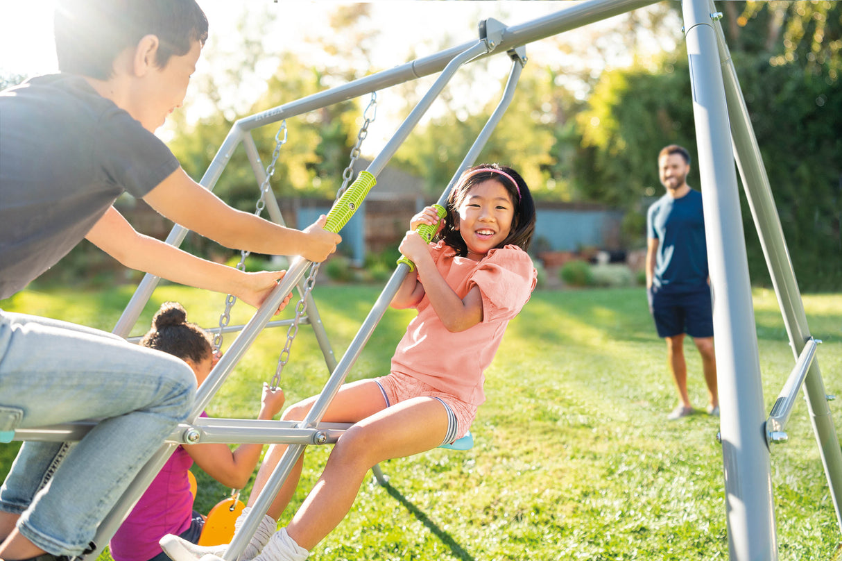 Children playing on the two feature swing set