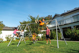 Children playing on the four feature swing set