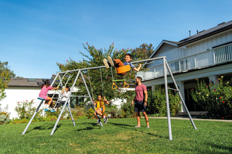 Children playing on the four feature swing set