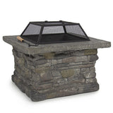 Victor Harbor faux stone fire pit table with iron bowl and BBQ grill on a patio
