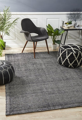 Nain black cotton rayon area rug with soft silk lustre in a modern living room