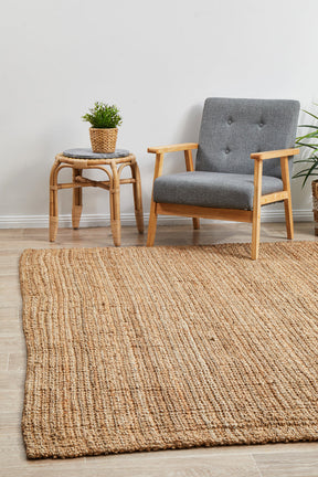 Isfahan natural jute area rug grounding a coastal living room