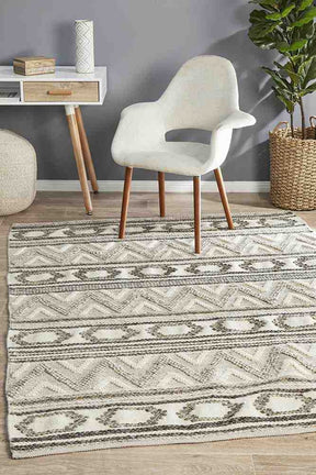 Heriz stone hand loomed wool viscose flatwoven area rug in a contemporary room