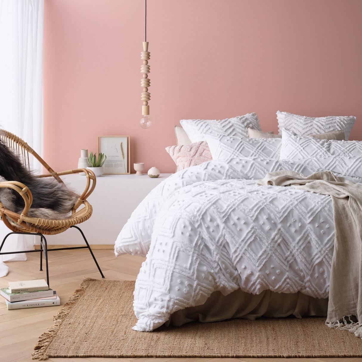 White medallion tufted cotton quilt cover with two pillowcases on a Queen bed