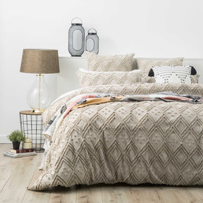 Stone medallion tufted cotton quilt cover with two pillowcases on a King bed