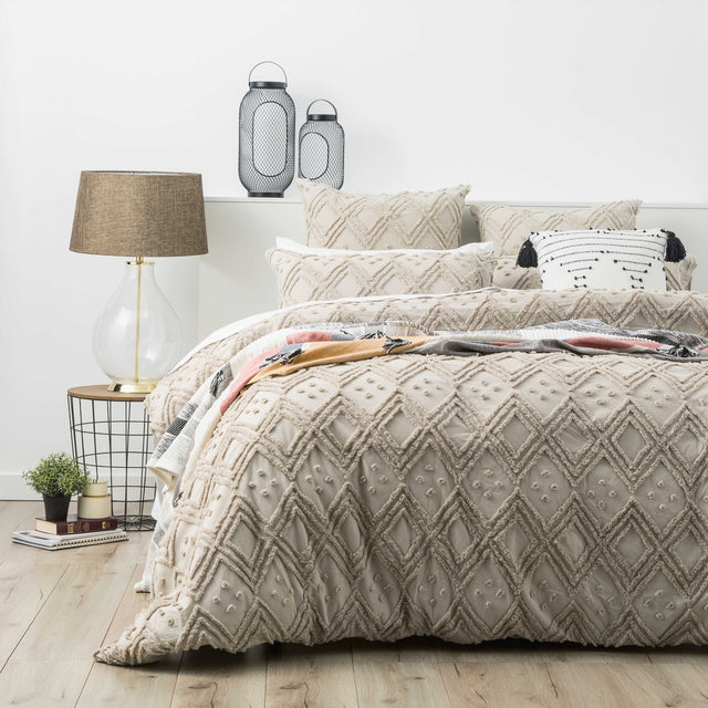 Stone medallion tufted cotton quilt cover with two pillowcases on a King bed