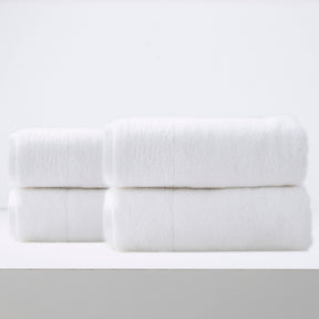 Lagos 650 GSM zero twist cotton bath sheets folded in a luxury bathroom
