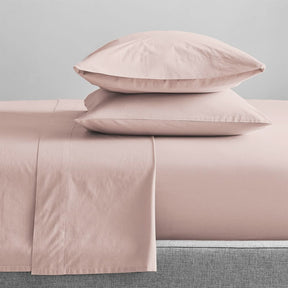 Sansepolcro sepia rose GOTS organic cotton sheet set on a bed