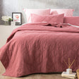 Foxcote rose stonewash cotton quilted coverlet set with two pillowcases on a bed