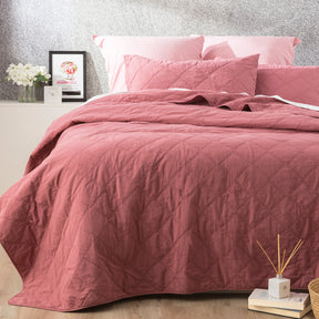 Foxcote rose stonewash cotton quilted coverlet set with two pillowcases on a bed