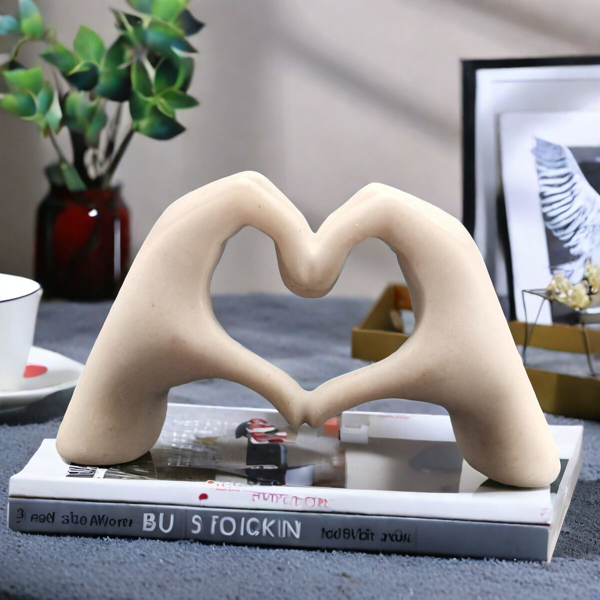White matte heart shaped sculpture on a bedside table