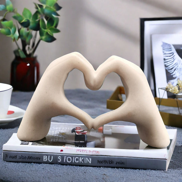 White matte heart shaped sculpture on a bedside table