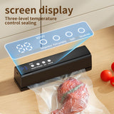 Cordless vacuum sealer in black sealing a food storage bag on a kitchen bench