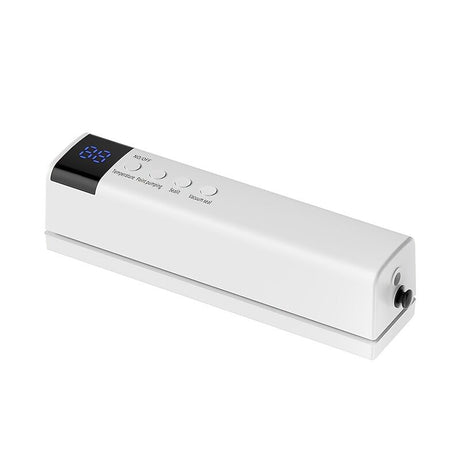 Portable vacuum sealer stored in a kitchen drawer alongside utensils