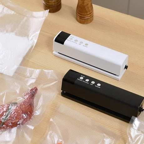 Black cordless vacuum sealer shown with vacuum bags ready for sealing