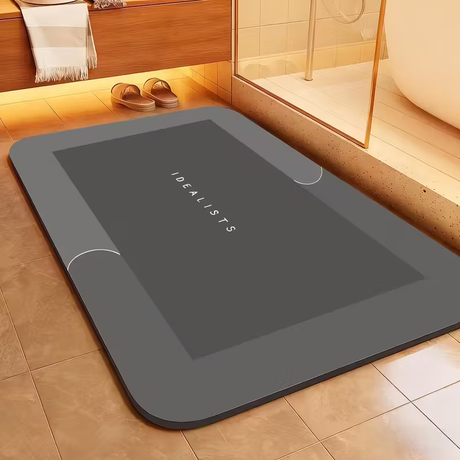 Dark grey super absorbent bath mat, 50 x 80 cm, laid flat on a bathroom floor