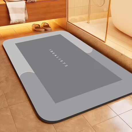 Light grey super absorbent bath mat, 50 x 80 cm, laid flat on a bathroom floor