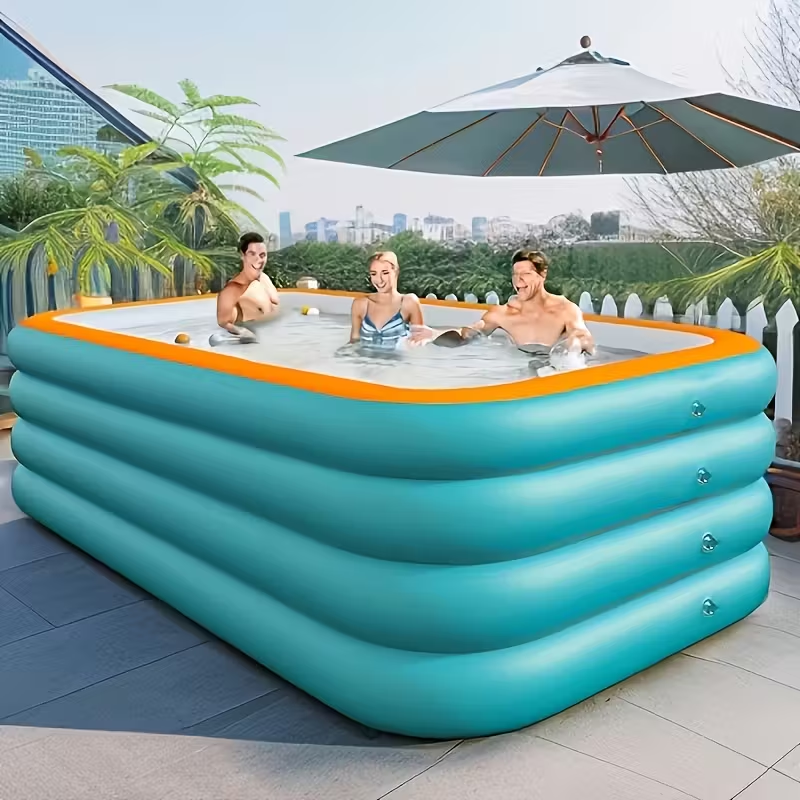 Green inflatable family swimming pool set up on a backyard lawn