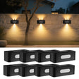 Solar up and down wall light with warm white glow on a fence