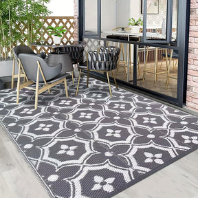 Reversible geometric braided outdoor patio mat