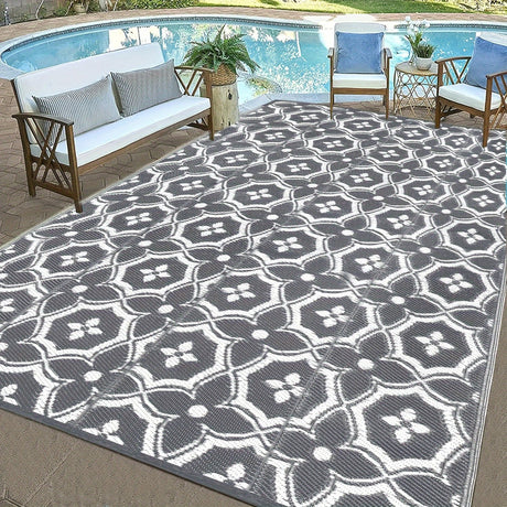 Reversible geometric braided outdoor patio mat