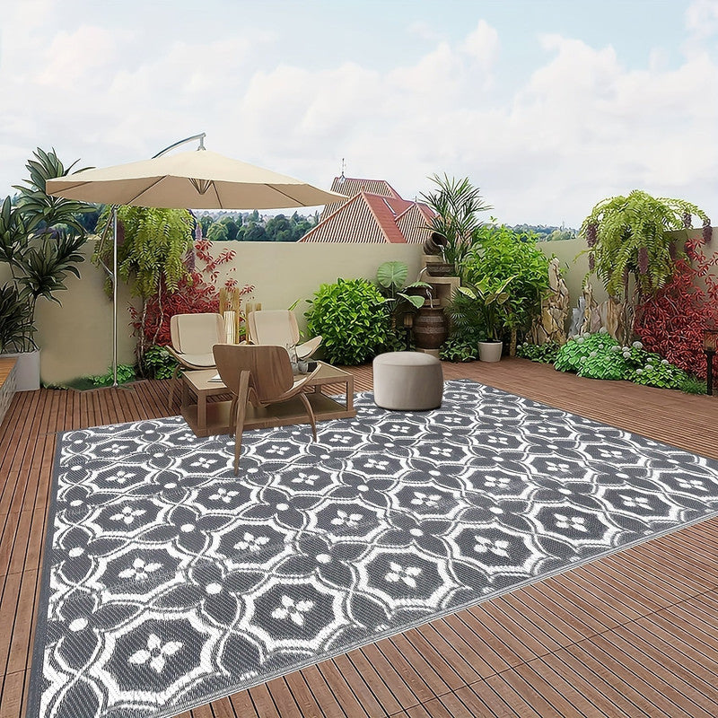 Reversible geometric braided outdoor patio mat