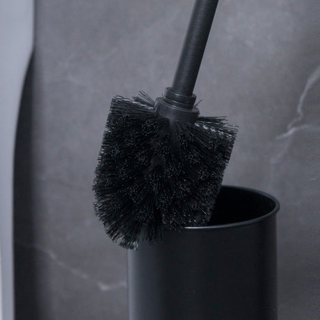Toilet brush lifted from the bamboo topped holder on the black bathroom stand