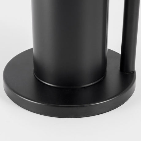 Black toilet roll rack in a bathroom setting with rolls stacked vertically