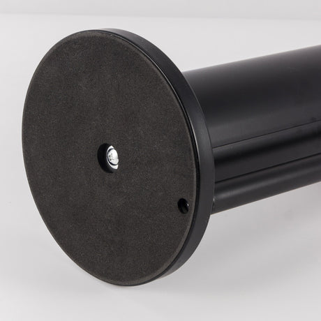 Toilet roll being pulled from the upright rack of the black freestanding stand