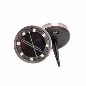 Solar garden spike light with warm white LEDs in a lawn